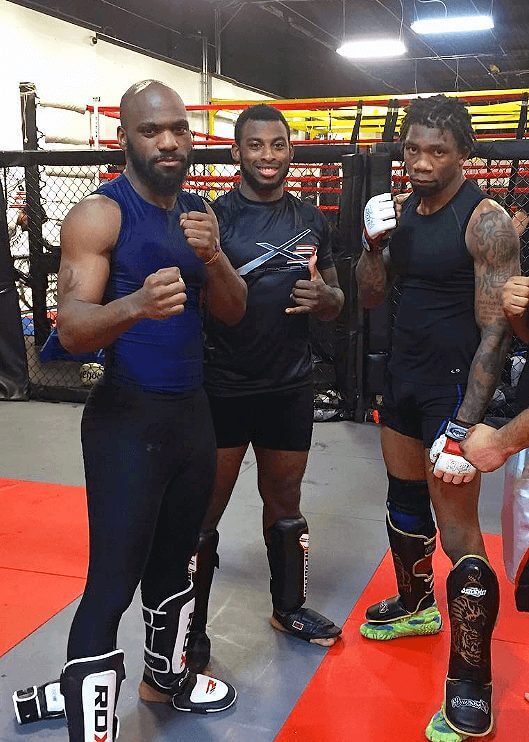 Muay Thai standup training with X3 Fight teammates DJ Wilson (left) and Robert Hale III (center)