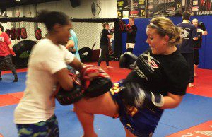 Kelly doing knee kicks with friend Brandy Nicole.