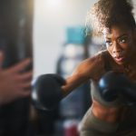 Woman Punching Boxing Bag |Why You Should Add Boxing To Your Workout Regimen | X3 Sports
