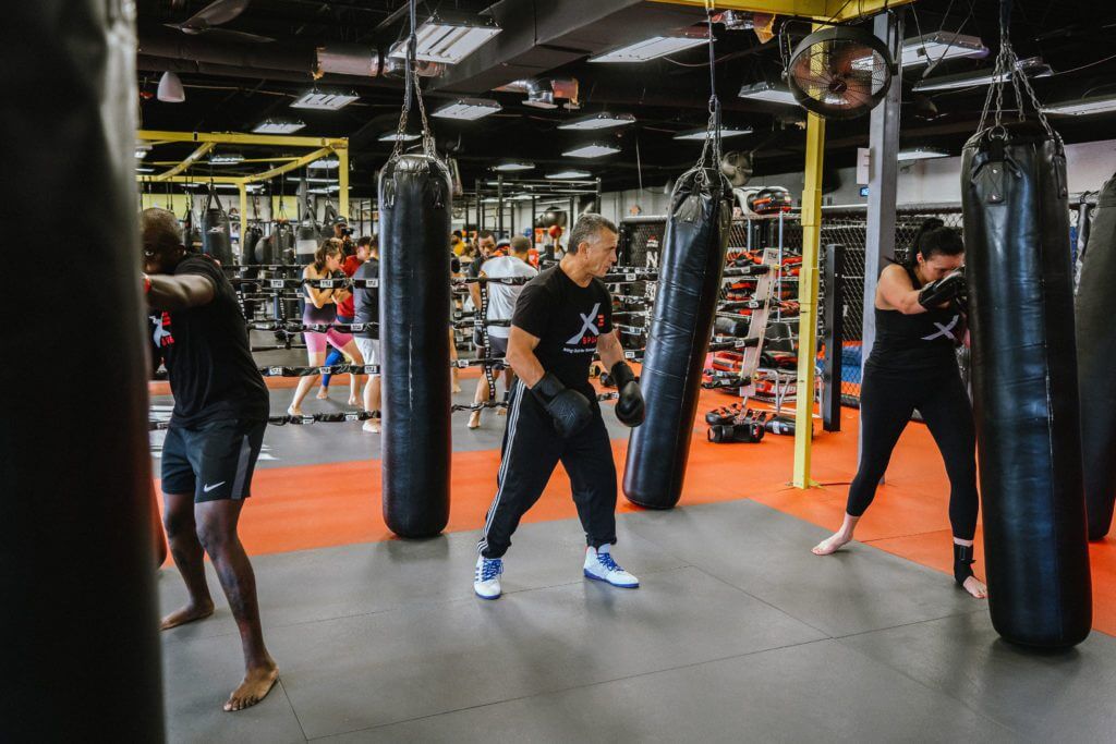 Instuctor-led group kickboxing class with cardio kickboxing benefits