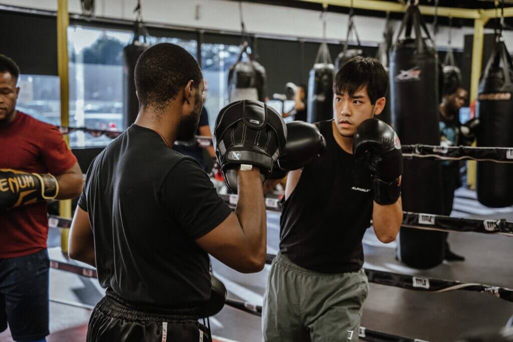 Pad work with boxing personal trainer at X3 Sports.