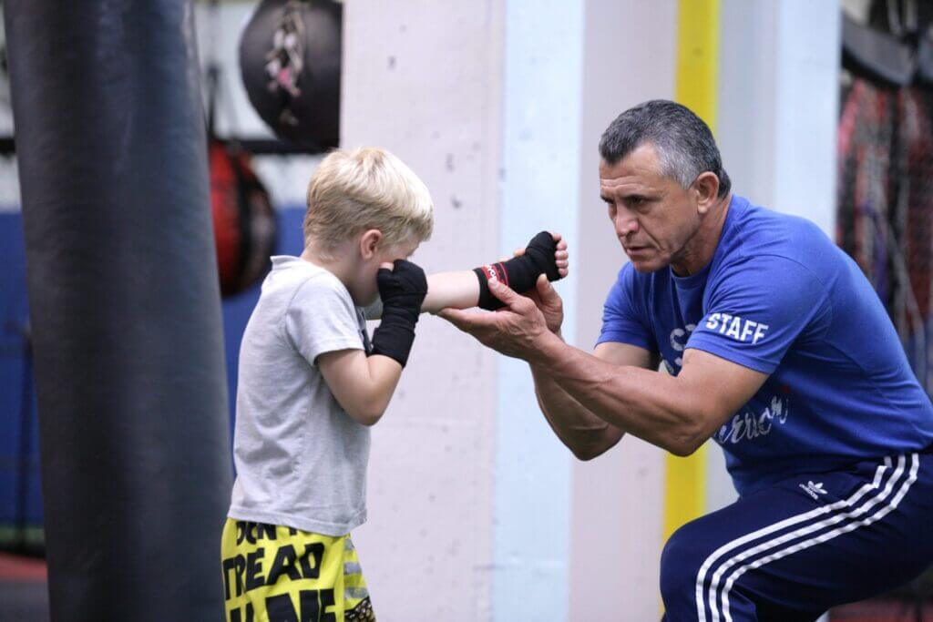 Kids in junior boxing classes at X3 get hands-on training and mentorship.