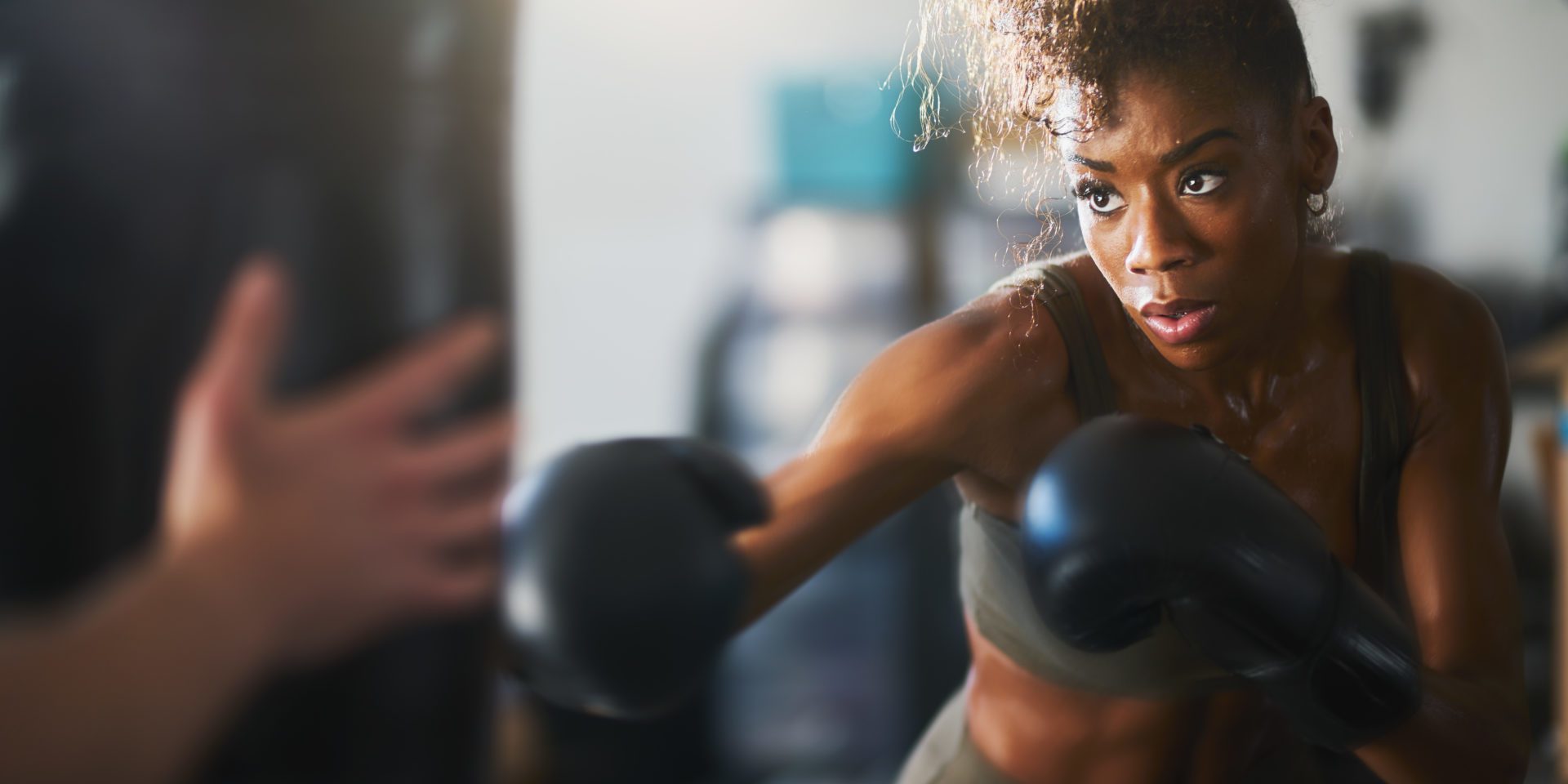 Woman Punching Boxing Bag |Why You Should Add Boxing To Your Workout Regimen | X3 Sports